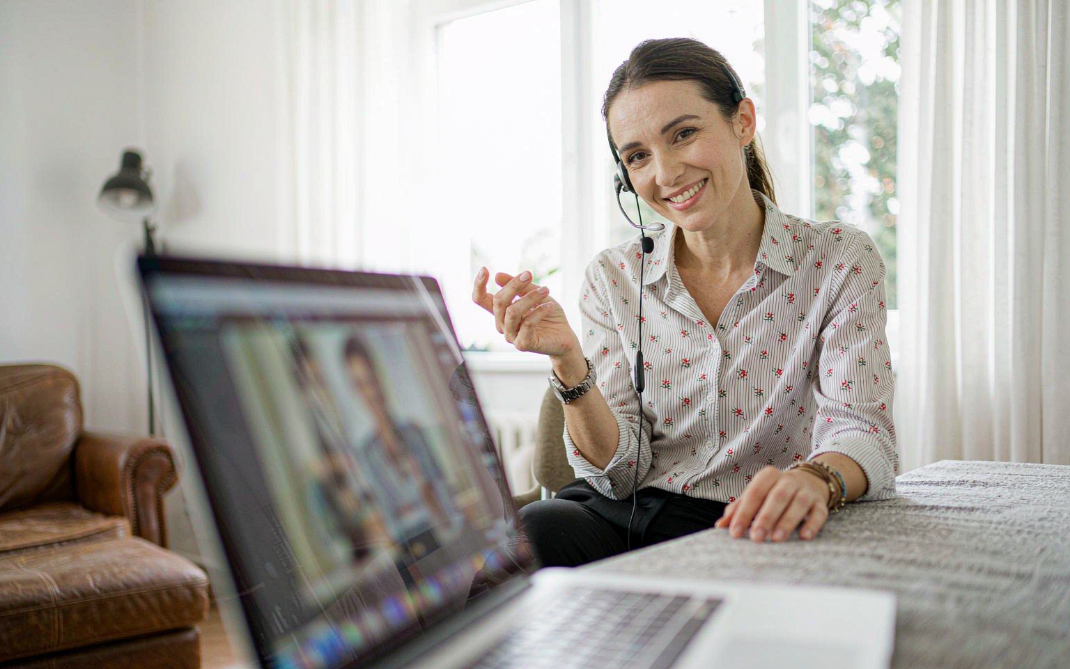 Small business owner on a friendly video consultation call in her home office